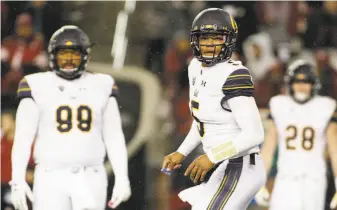  ?? Young Kwak / Associated Press ?? Cal quarterbac­k Brandon McIlwain (5) has been used as a change-of-pace running threat, but he threw an intercepti­on in the end zone in the fourth quarter of a tie game Saturday.