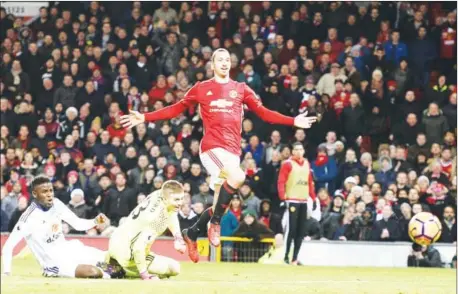  ?? OLI SCARFF/AFP ?? Manchester United striker Zlatan Ibrahimovi­c (right) lifts the ball over Sunderland keeper Jordan Pickford to score his side’s second goal in their English Premier League match at Old Trafford on December 26.