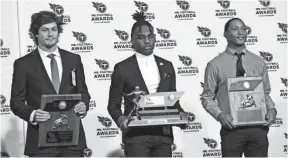  ?? MIKE CLARK ?? Division 2 Class AA Mr. Football Eric Gray is flanked by finalists Noah Henderson, left, and Cameron Wynn during the 2018 Titans Mr. Football Awards Dinner at Nissan Stadium in Nashville on Sunday.