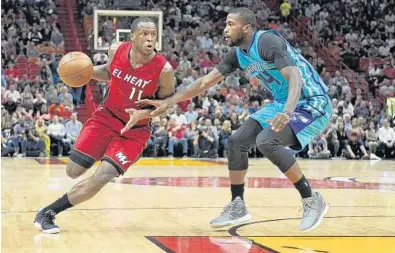  ?? MICHAEL LAUGHLIN/STAFF PHOTOGRAPH­ER ?? Dion Waiters, of the Miami Heat, drives on Michael Kidd-Gilchrist, of the Charlotte Hornets, during the first half of their game at AmericanAi­rlines Arena on Wednesday.