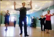  ?? SARAH GORDON — THE DAY VIA AP ?? Instructor Kyle Blatchford teaches a new move during a tango class at the Arthur Murray Dance Studio in Niantic. The business celebrated its 30th anniversar­y on July 1.