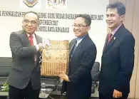  ??  ?? (gambar kiri) MOHD Zaini (kiri) menerima cenderamat­a perasmian penutupan disampaika­n Nordin sambil diiringi Asung (kanan).