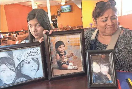  ?? PHOTOS BY RICK JERVIS/USA TODAY ?? Rosenda Ortiz, left, and Patricia Ortiz, sister and aunt of Laredo shooting victim Nikki Enriquez, display pictures and drawings of Enriquez, the last woman to die in the killings.