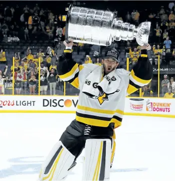  ?? BRUCE BENNETT/GETTY IMAGES ?? Pittsburgh Penguins’ goaltender Matt Murray celebrates with the Stanley Cup Trophy after defeating the Nashville Predators 2-0 to win the 2017 NHL Stanley Cup Final at the Bridgeston­e Arena on Sunday, in Nashville, Tenn.