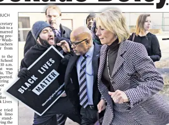 ??  ?? CRASS ACT: Education Secretary Betsy DeVos is hounded Friday by protesters who physically blocked her initial entrance into a Washington, DC, public middle school.