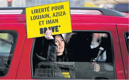  ??  ?? A demonstrat­or from Amnesty Internatio­nal holds a placard outside the Saudi Arabian Embassy to urge Saudi authoritie­s to release jailed women’s rights activists Loujain al-Hathloul, Eman al-Nafjan and Aziza al-Yousef in Paris, France, on Internatio­nal Women’s Day on March 8. The placard reads, ‘Freedom for Loujain, Aziza and Iman’.