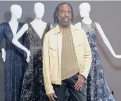  ?? DAMIAN DOVARGANES/AP ?? Kevan Hall with his“Galaxy Collection”at his haute couture atelier March 19 in West LA. He’s been getting calls from clients about dressed-up looks.