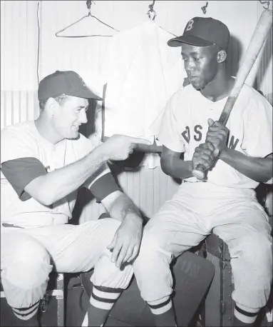  ?? Associated Press file photo ?? Elijah “Pumpsie” Green, right, is given some friendly tips by Ted Williams in 1959. Green was the first African American ever to play for the Red Sox.