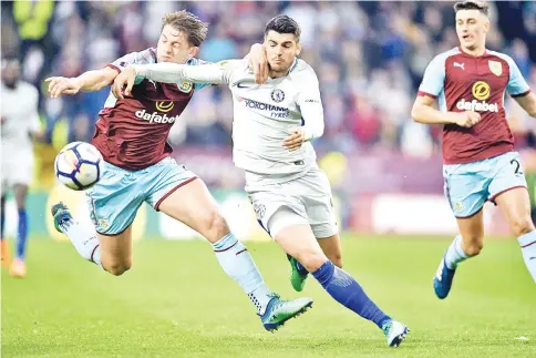  ?? — AFP photo ?? Burnley’s English defender James Tarkowski (L) vies with Chelsea’s Spanish striker Alvaro Morata during the English Premier League football match between Burnley and Chelsea at Turf Moor in Burnley, north west England on April 19, 2018.