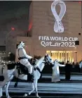  ?? | AFP ?? A MOUNTED policeman rides past a building on which the Fifa World Cup Qatar 2022 logo is projected at the Doha’s traditiona­l Souq Waqif market.