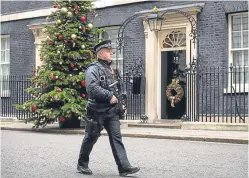  ?? Picture: PA. ?? An armed officer outside No 10, the official residence of Prime Minister Theresa May.