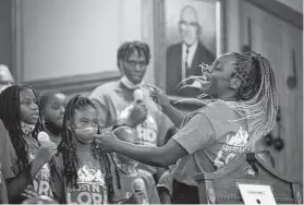  ?? Mark Mulligan / Staff photograph­er ?? Korra Williams leads the youth choir during a 75th anniversar­y celebratio­n for the Greater Mount Olive Missionary Baptist, a historic Black church.