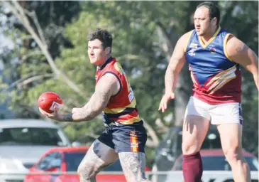  ??  ?? Longwarry’s Jake Delphine looks for a passing option during Saturday’s qualifying final.
