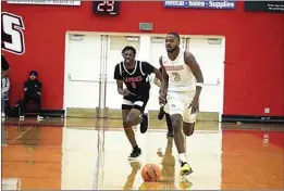  ?? COURTESY OF BC ATHLETICS ?? Bakersfiel­d College’s Elijah Williams dribbles downcourt ahead of L.A. Pierce’s Jamarie’ Bailey in Saturday’s game at the Gils Bishop Sports Center.