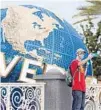  ?? GREGG NEWTON/AFP ?? A visitor takes a selfie at Universal Orlando Resort theme park.