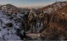 ?? ?? Ukrainian soldiers of the 41st brigade stand in a trench near the frontline, outside Kupiansk, Kharkiv region.