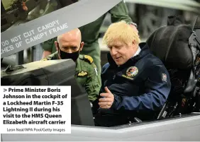  ?? Leon Neal/WPA Pool/Getty Images ?? > Prime Minister Boris Johnson in the cockpit of a Lockheed Martin F-35 Lightning II during his visit to the HMS Queen Elizabeth aircraft carrier