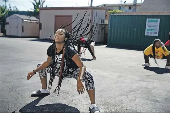  ?? Photograph­s by Dania Maxwell Los Angeles Times ?? KAMRYN JOHNSON dances with her team after school at View Park Prep. After Nipsey Hussle was killed nearby, she says, she returned to school with new resolve.