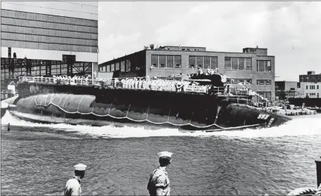  ?? AP PHOTO ?? The 279-foot nuclear submarine Thresher, prototype of the world’s most advanced class of nuclear attack subs, is launched bow-first at Portsmouth Navy Yard July 9, 1960. It was believed to be the first time a major Navy ship had been launched bow-first...