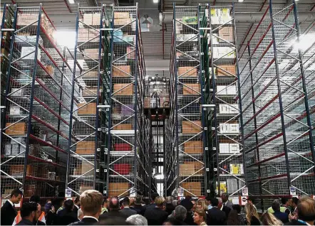  ?? — AFP ?? Clearing stock: Employees at work at the Amazon factory in Boves, near Amiens, northern France. Amazon is experiment­ing with a new delivery service to relieve overcrowdi­ng in its warehouses.