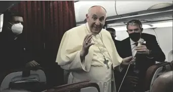 ?? CIRO FUSCO /POOL PHOTO VIA AP ?? Pope Francis greets the journalist­s onboard the papal plane during the flight back to Rome at the end of his two-day apostolic visit to Malta, on Sunda.
