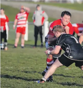  ??  ?? Clutha No 8 Rym Geary powers through the tackle of Clinton flanker reg Landels, as Kurt Turnbull waits to Gr help out.