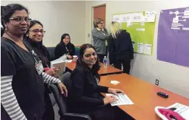  ?? Photo courtesy of Duke Rohe, The University of Texas MD Anderson Cancer Center ?? Harjeet Kaur, clinical nurse leader (seated front); Anitha Madhu, clinical charge nurse (left); Tessy Siby, clinical nurse leader; Phuong Tran (seated, no longer at MD Anderson); and Colleen Hughes, registered nurse (back to camera), prioritize steps...