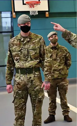  ??  ?? ORDER OF BATTLE: Soldiers of the Scots Dragoon Guards get their instructio­ns in preparatio­n to transform the Donald Dewar Centre for vaccinatio­ns