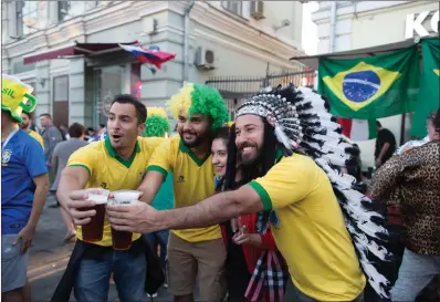  ?? Washington Post photo ?? Fans of Brazil’s national team celebrated Monday morning’s 2-0 win over Mexico to advance to the World Cup quarterfin­als Sunday against Belgium. Neymar delivered a goal and an assist.