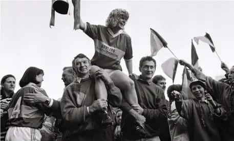  ??  ?? Kerry captain Eileen Lawlor (now Dardis) is shouldered by former Kerry footballer Johnny Bunyan (left), and her sister Margaret’s husband, Willie Slattery , following Kerry’s victory in the 1993 All-Ireland Football Final against Laois at Croke Park. Photo by Sportsfile