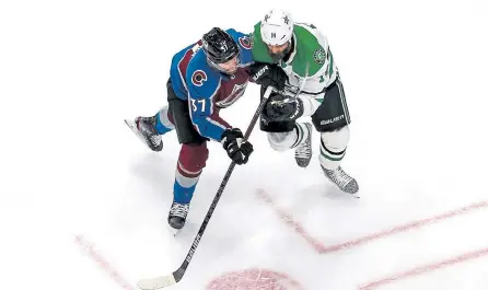  ?? Bruce Bennett, Getty Images ?? Dallas’ Jamie Benn, right, checks Colorado’s J.T. Compher during the first period on Monday night.