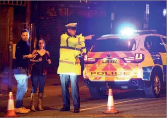  ?? DAVE THOMPSON / GETTY IMAGES ?? Police stand by a cordoned off street close to the Manchester Arena on Monday in Manchester, England, following an explosion at a concert by American pop singer Ariana Grande at the 21,000-seat arena.