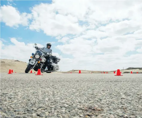  ?? BRANDON HARDER ?? An RCMP officer takes part in a motorcycle recertific­ation course Saturday at RCMP Depot in Regina. Officers have to recertify each year and are tested on four mandatory skills, including a 180-degree U-turn. Those who don’t pass must take eight hours...