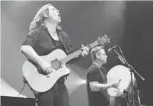  ?? WAYNE CUDDINGTON/OTTAWA CITIZEN ?? Alan Doyle and Sean McCann of Great Big Sea whooped the crowd into a frenzy with a rousing performanc­e on the Bell Stage Friday evening.