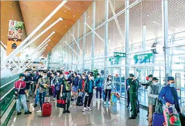  ?? CAMBODIAN EMBASSY IN MALAYSIA ?? Cambodians await their flight to Cambodia at a Malaysia airport in July.