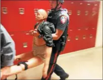  ?? PHOTOS COURTESY OF MONTGOMERY COUNTY DEPARTMENT OF PUBLIC SAFETY ?? Lower Pottsgrove Police carry a dummy representi­ng a shooting victim to safety during an active shooter drill held June 11 at Pottsgrove High School.