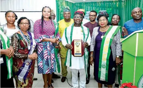  ?? ?? President, Nigerian Medical Associatio­n ( NMA), Prof. Innocent Ujah ( middle) with an award presented to him by the Medical Women Associatio­n of Nigeria ( MWAN) at the opening ceremony of the ongoing NMA’S 62nd Annual General Conference and Delegates Meeting in Port Harcourt, Rivers State.