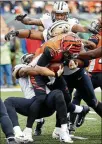  ?? JOE ROBBINS / GETTY IMAGES ?? Saints defenders swarm Bengals quarterbac­k Andy Dalton during New Orleans’ 51-14 victory at Paul Brown Stadium.