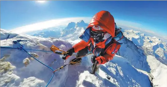  ?? ?? Wang, a 34-year-old man diagnosed with ankylosing spondyliti­s, or AS, climbs the world’s tallest peak Mount Qomolangma.