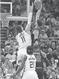  ?? MCLOONE/USA TODAY SPORTS
MICHAEL ?? The Celtics’ Jayson Tatum, top right, dunks over the Bucks’ Brook Lopez, top left, Monday in Milwaukee.