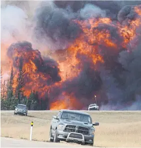  ?? JONATHAN HAYWARD THE CANADIAN PRESS
FILE PHOTO ?? Natural disasters like the 2016 wildfire in Fort McMurray, Alta., are just one reason to create an emergency fund that will cover three to six months of emergency spending.