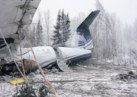  ??  ?? Wreckage of the ATR 42 operated by West Wind Aviation sits in the bush close to the runway at the Fond du Lac airport. The plane crashed Wednesday night with 25 people on board. No one was killed but several suffered injuries. The cause of the crash is...