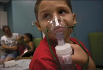  ??  ?? In this May 29 photo, Yahir Garcia receives one of his asthma at a medical center in San Juan, Puerto Rico. AP PHOTO/RAMON ESPINOSA