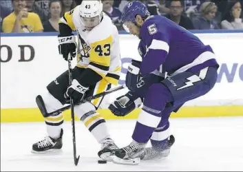  ?? Chris O'Meara/Associated Press photos ?? Penguins winger Conor Sheary and Tampa Bay Lightning defenseman Dan Girardi battle for the puck in the first period.