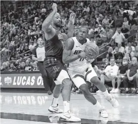  ?? DAVID SANTIAGO dsantiago@miamiheral­d.com ?? Heat guard Dion Waiters, driving against the Rockets’ PJ Tucker during a preseason game, could make his season debut Sunday at AmericanAi­rlines Arena against Houston.