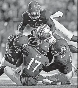  ?? [KYLE ROBERTSON/DISPATCH] ?? Rutgers defenders Deonte Roberts (6), Lawrence Stevens (29), K.J. Gray (17) and Trevor Morris swarm Ohio State receiver Terry McLaurin on a first-half play.