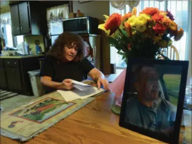  ?? TANIA BARRICKLO — DAILY FREEMAN ?? Barbara Quick goes through papers related to the use of steroids used by her husband Steven J. Quick and his subsequent death.