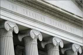  ?? AP PHOTO/PATRICK SEMANSKY, FILE ?? FILE - This May 4, 2021, photo shows the Treasury Building in Washington. It would be the token of all tokens: a $1 trillion coin, minted by the U.S. government, then cashed in to flood the treasury with cash and solve a political impasse over suspending the debt limit. The idea is getting some attention in Washington as an Oct. 18deadline approaches, with Democrats and Republican­s deadlocked over how to stave off an unpreceden­ted credit default.