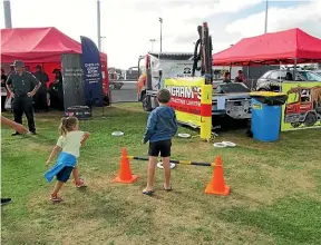  ?? ?? Two children play quoits at the 2021 family fun day organised by South Taranaki Neighbourh­ood Support. This year’s event is on February 11 at the Hub in Hā wera.