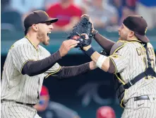  ?? RONALD MARTINEZ/GETTY ?? Victor Caratini, right, became the first MLB catcher to be behind the plate for consecutiv­e no-hitters in the league for different teams Friday.